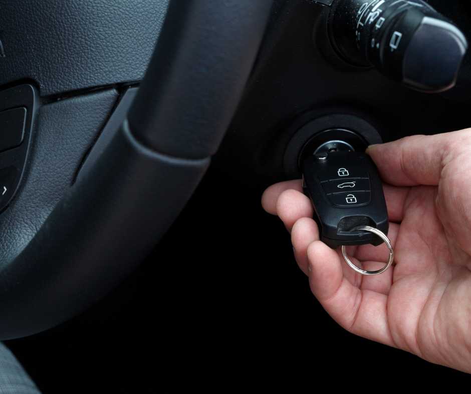 A close-up of a car ignition with a key inserted.